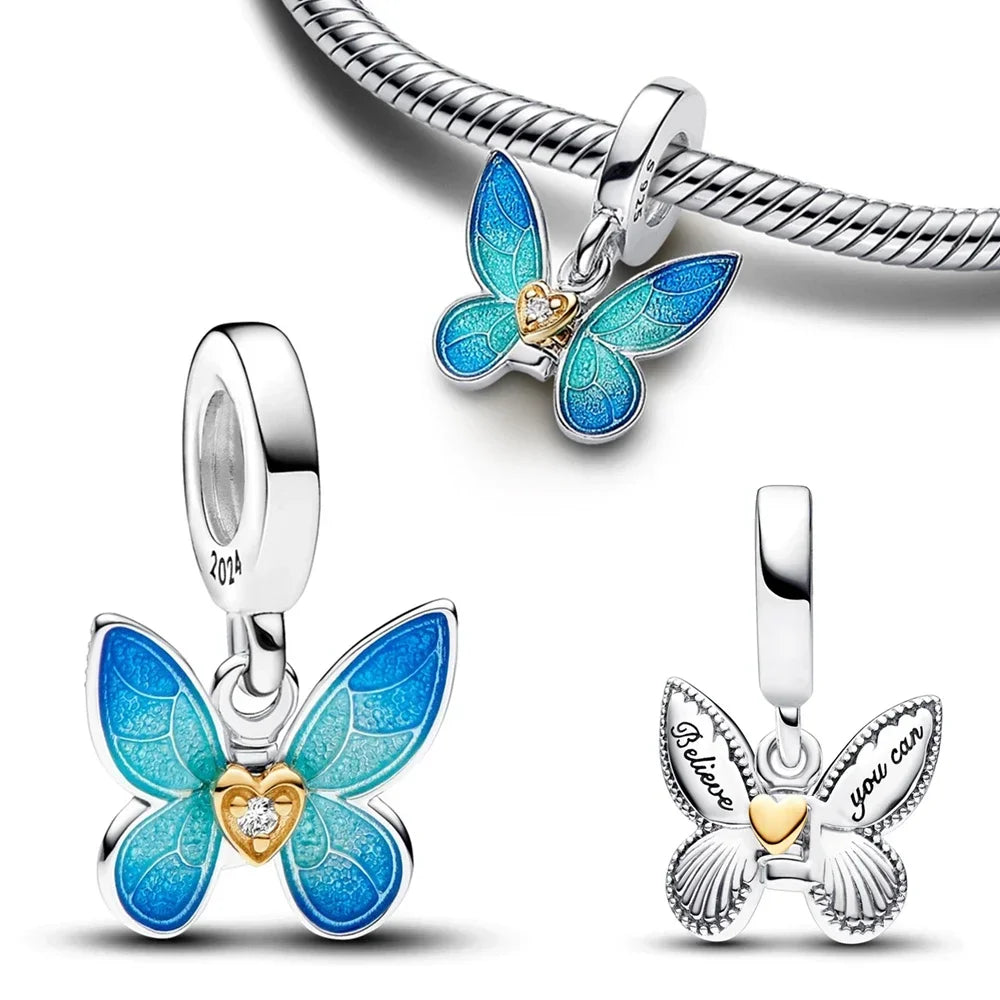 A showing of the Blue Butterfly Bracelet Charm that has a beautiful gold heart in the middle, the year 2024 engraved on the hoop band, and the words Believe you can engraved in the back with another gold heart. It is on a white background giving the front view, back view, and what it would look like on a bracelet.  