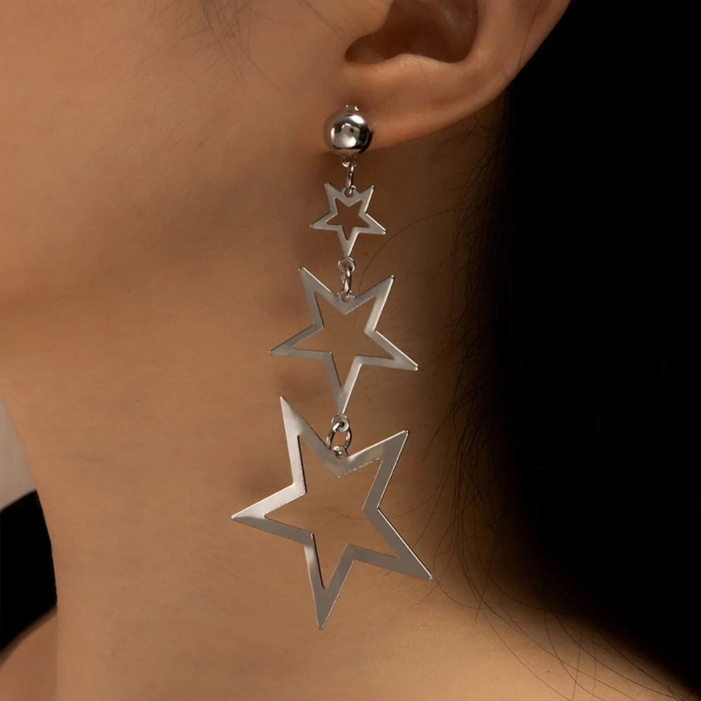 A showcasing of the silver version of the Kpop Inspired Triple Star Drop Earrings on a female model in her ear to give speculation of the length.