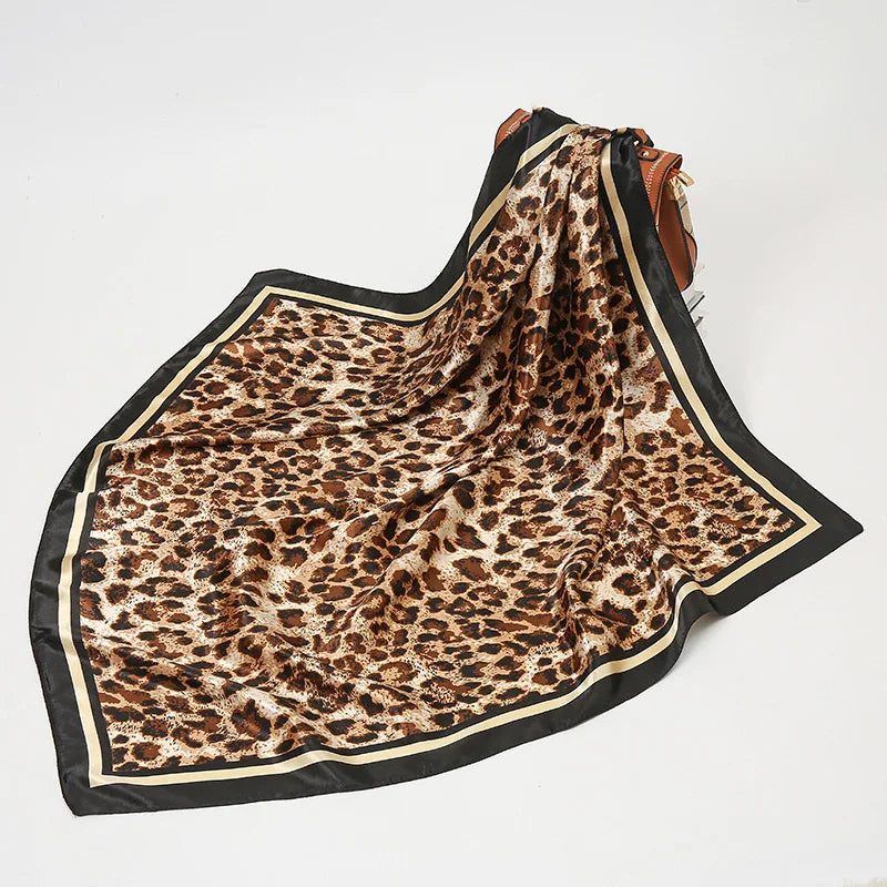 Leopard Print Scarf with Black Border with purse behind it for a size reference. 