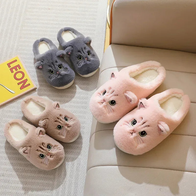 A showcase of three of the Fuzzy Cat Unisex House Slippers in the colors brown, gray, and pink in a living room setting. 