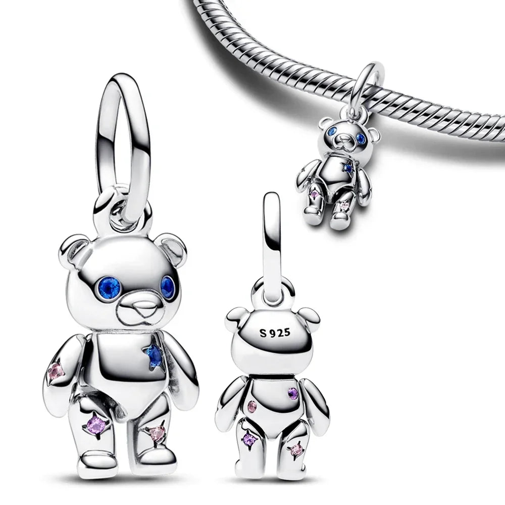 A showing of the Silver Bear Bracelet Charm that is adorned with light pink and blue gems on a white background giving a front view, back view, and what it would look like on the bracelet itself.