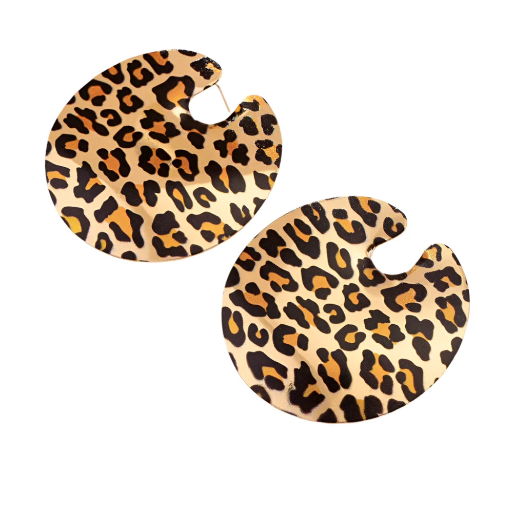 A pair of round earrings with a leopard print pattern. The earrings are flat and have a small cut-out near the top for the earring hook. The background white.