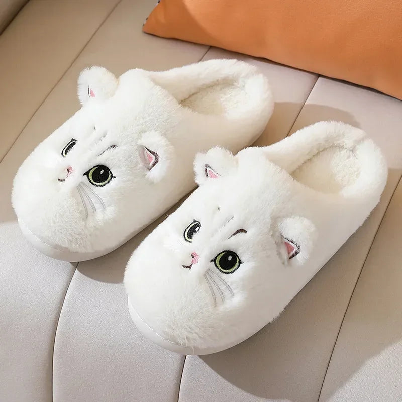 A showcase of the White Fuzzy Cat Unisex House Slippers on a white leather seat. This white is more of a pure white. 